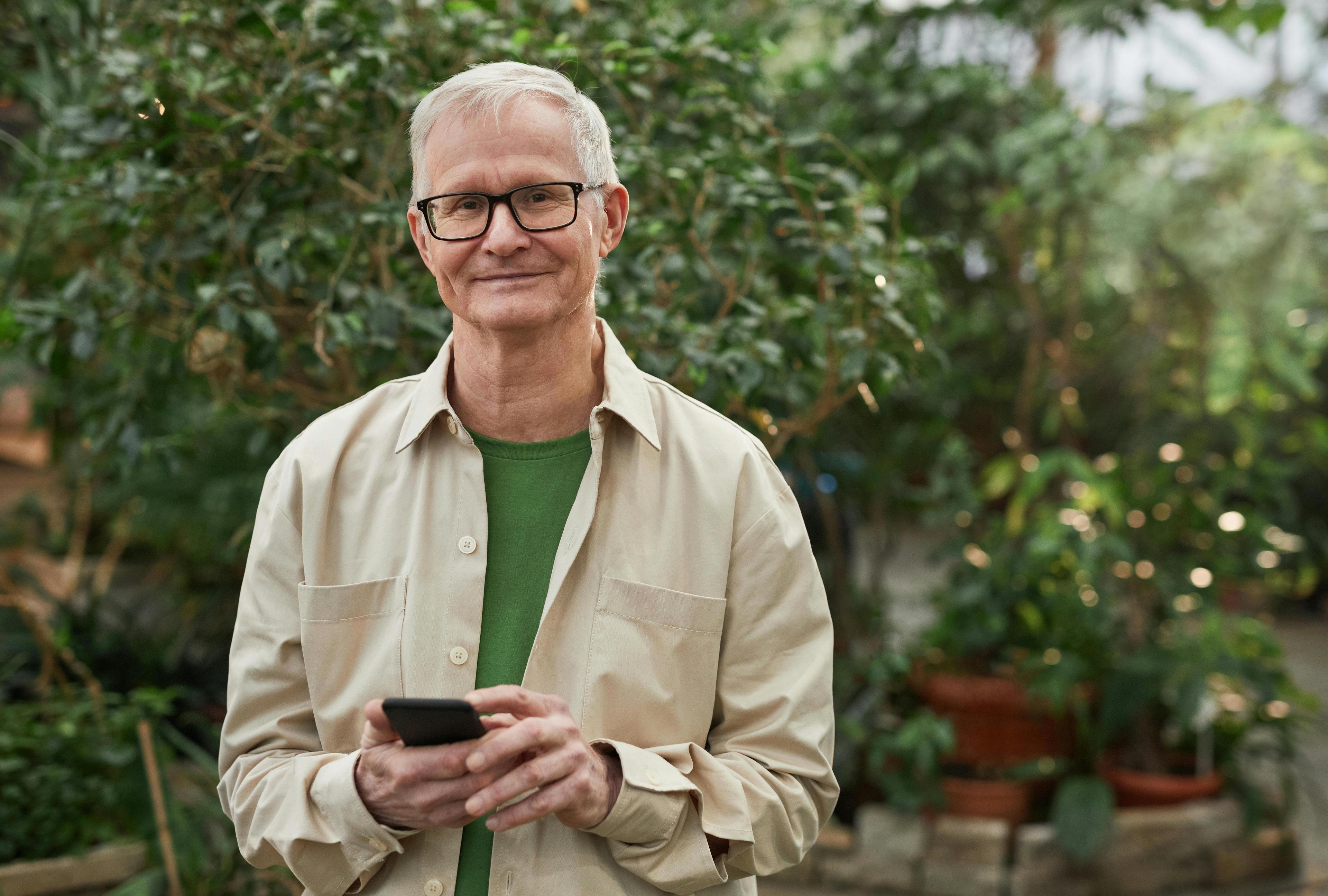 Guy with phone in garden